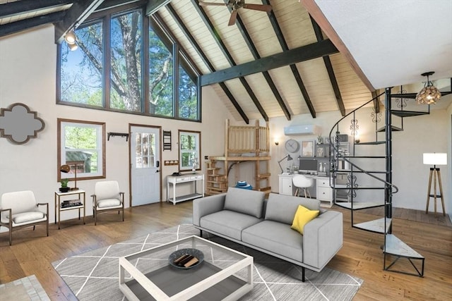 living room with wood-type flooring, an AC wall unit, high vaulted ceiling, and beam ceiling
