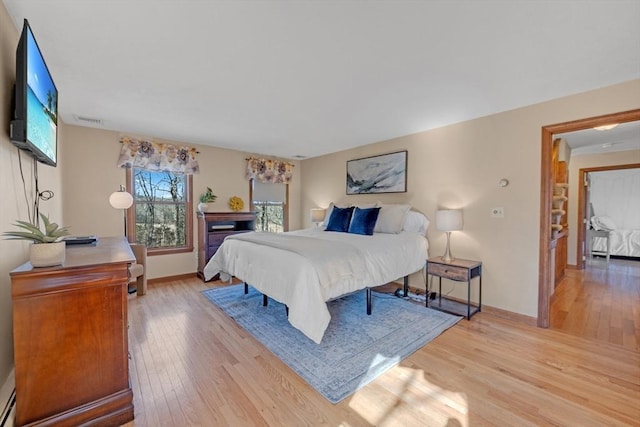 bedroom featuring light wood-type flooring and baseboards