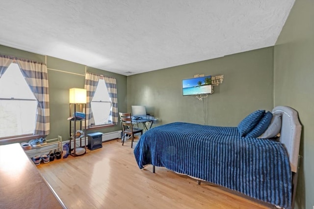 bedroom with wood finished floors and a textured ceiling