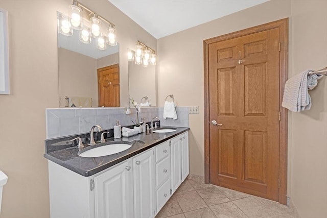 full bathroom featuring tile patterned flooring, decorative backsplash, and a sink