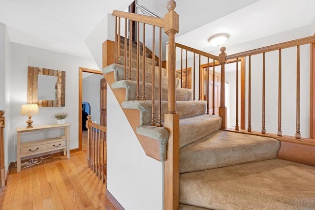 staircase featuring wood finished floors