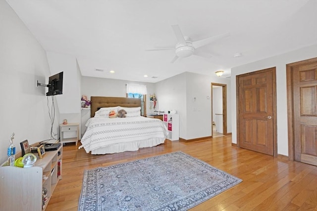 bedroom with baseboards, ceiling fan, and light wood finished floors