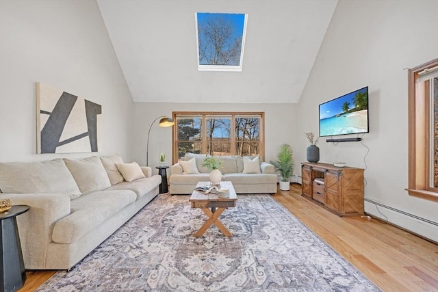 living area featuring light wood-style floors, baseboard heating, and high vaulted ceiling