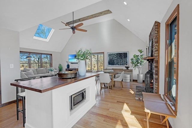 kitchen with a wealth of natural light, light wood-style floors, open floor plan, and butcher block counters