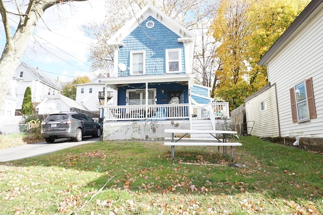 view of front facade with covered porch and a front lawn