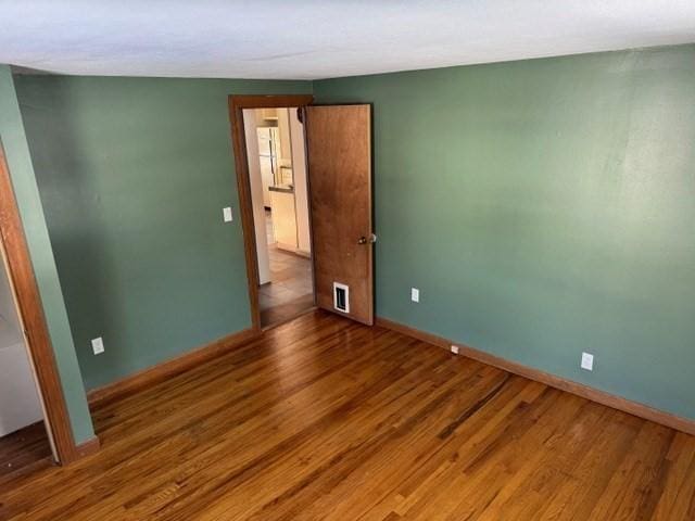 unfurnished room with wood-type flooring