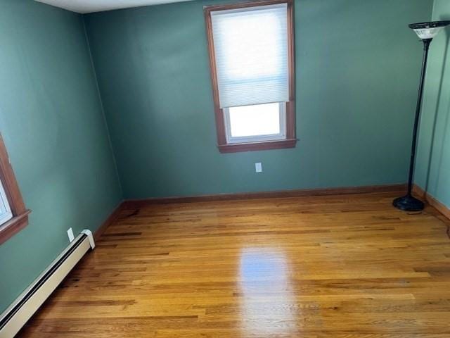 spare room with light hardwood / wood-style flooring and a baseboard heating unit