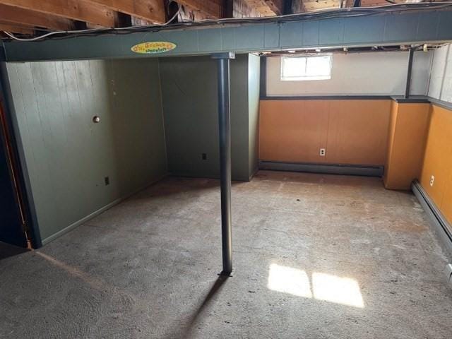 basement featuring a baseboard heating unit