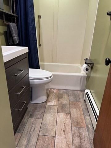 bathroom with vanity, toilet, and baseboard heating