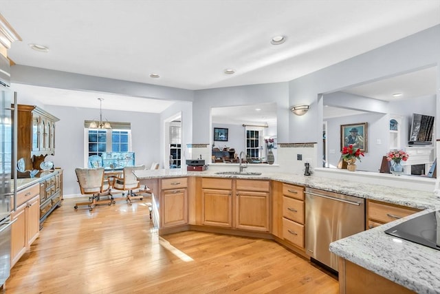 kitchen featuring dishwasher, light brown cabinets, sink, light hardwood / wood-style flooring, and an inviting chandelier