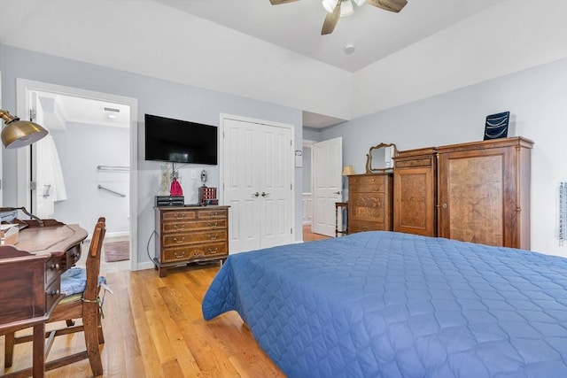 bedroom with ceiling fan, light hardwood / wood-style floors, and a closet