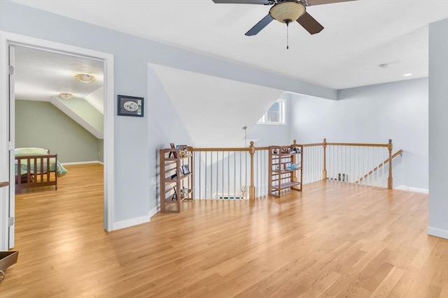 spare room featuring ceiling fan, light hardwood / wood-style flooring, and vaulted ceiling