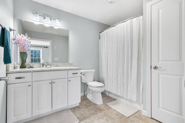 bathroom featuring a shower with shower curtain, tile patterned floors, vanity, and toilet