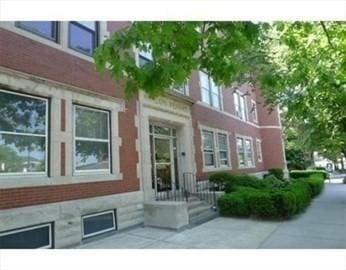 514 Harvard St Unit 2D, Brookline, MA 02446 - doorway to property featuring brick siding