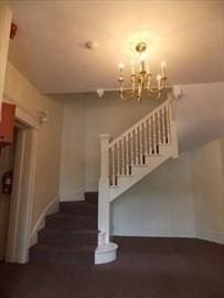 514 Harvard St Unit 2D, Brookline, MA 02446 - stairs with a chandelier