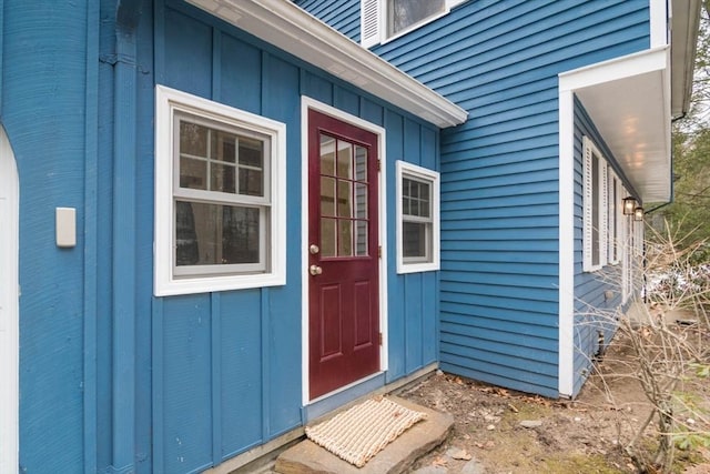 property entrance featuring board and batten siding