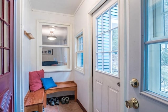 entryway featuring tile patterned flooring, plenty of natural light, and crown molding