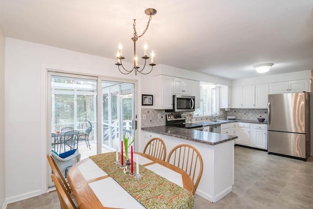 dining room with baseboards and a chandelier