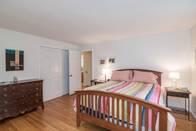 bedroom with a closet and wood finished floors