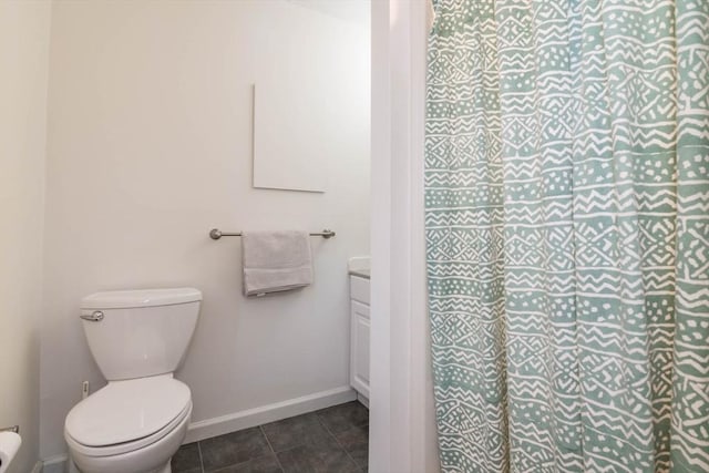 full bathroom with vanity, baseboards, a shower, tile patterned floors, and toilet