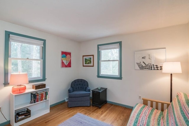 living area with wood finished floors and baseboards