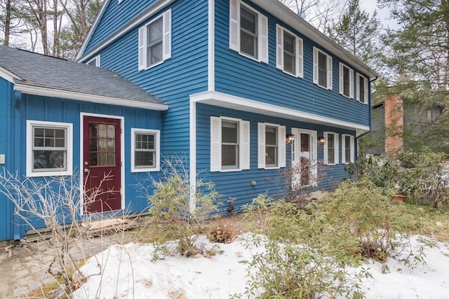 view of front of house with board and batten siding and roof with shingles