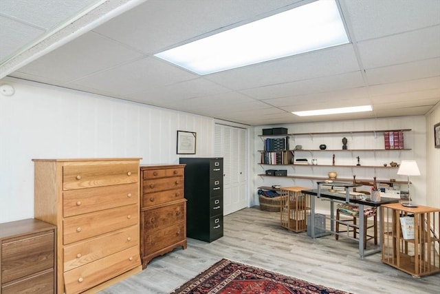 interior space featuring a paneled ceiling and light wood-style flooring