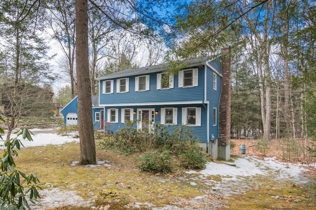 colonial-style house featuring a chimney