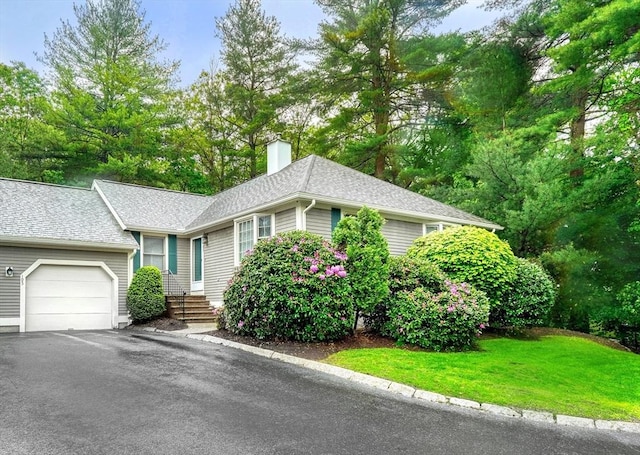 501 Lexington St Unit 105, Waltham, MA 02452 - ranch-style home with a chimney, a garage, asphalt driveway, roof with shingles, and a front lawn