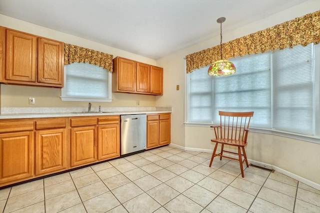 501 Lexington St Unit 105, Waltham, MA 02452 - kitchen with dishwasher, a sink, light countertops, pendant lighting, and brown cabinetry