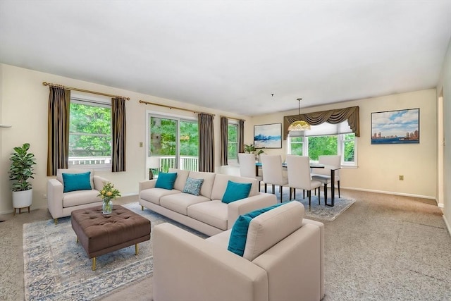 501 Lexington St Unit 105, Waltham, MA 02452 - living room featuring healthy amount of natural light, baseboards, and carpet flooring