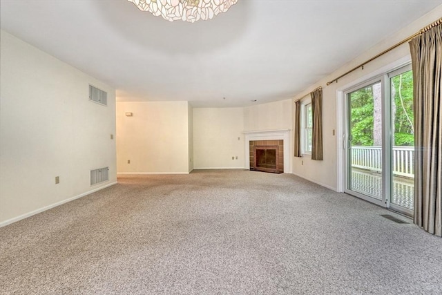501 Lexington St Unit 105, Waltham, MA 02452 - unfurnished living room featuring carpet flooring, baseboards, and a tile fireplace