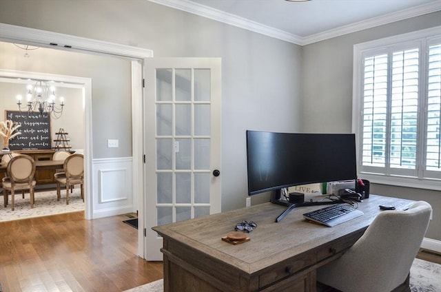 office featuring hardwood / wood-style floors, a chandelier, and ornamental molding