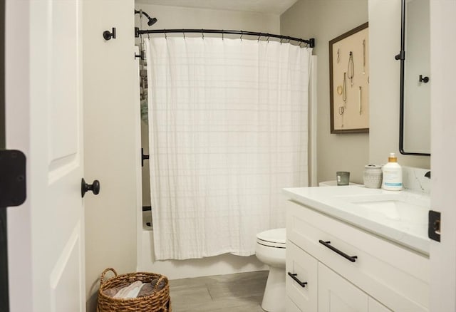 full bathroom with shower / bath combination with curtain, vanity, and toilet