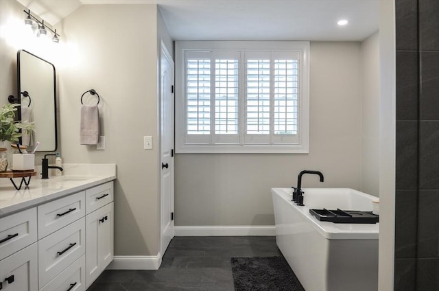 bathroom featuring vanity and a bath