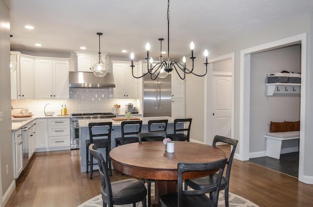 dining space with dark hardwood / wood-style floors and a notable chandelier