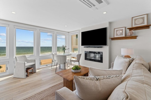 living room with visible vents, recessed lighting, a healthy amount of sunlight, and light wood-style floors