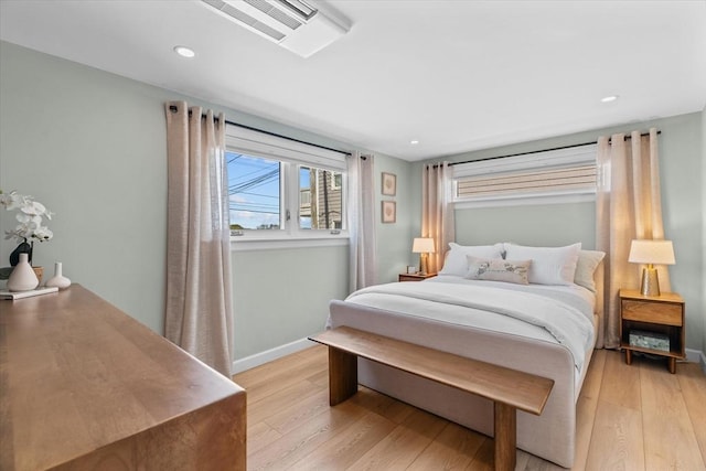 bedroom featuring baseboards, recessed lighting, visible vents, and light wood finished floors