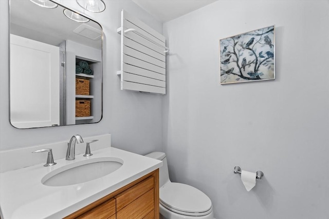 half bathroom featuring toilet and vanity