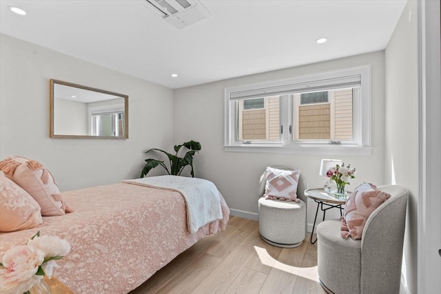 bedroom with wood finished floors, recessed lighting, visible vents, and baseboards