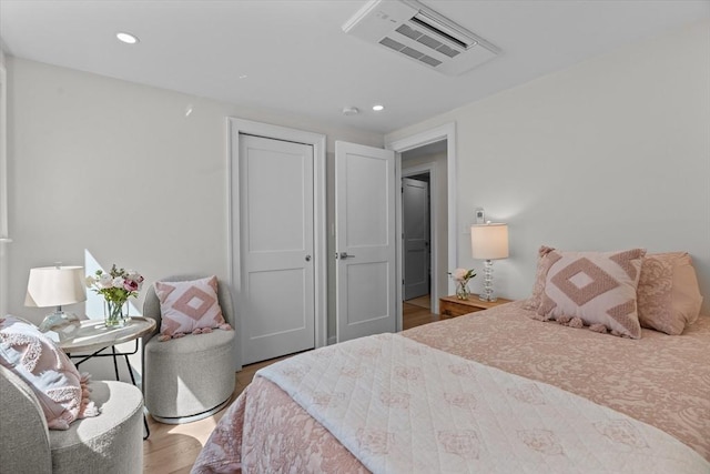 bedroom featuring recessed lighting, visible vents, and wood finished floors