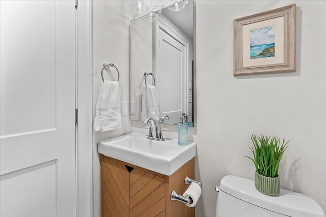 bathroom featuring toilet and vanity