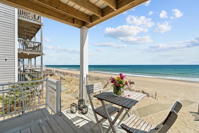 deck featuring a beach view and a water view