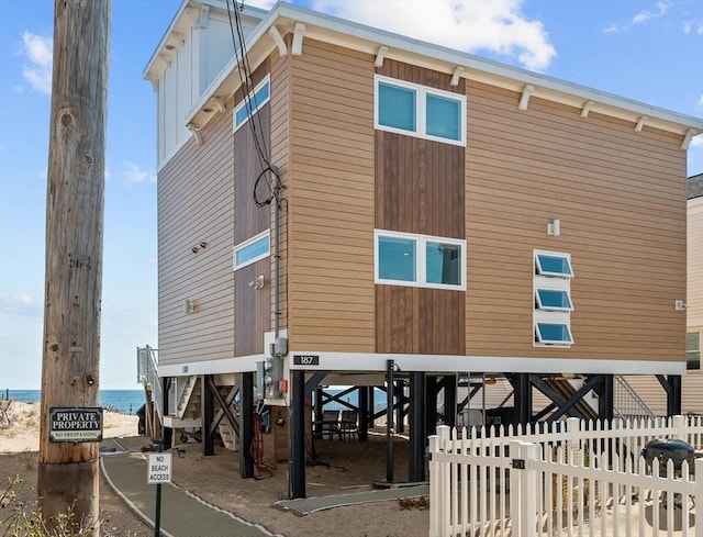 exterior space with fence and a water view