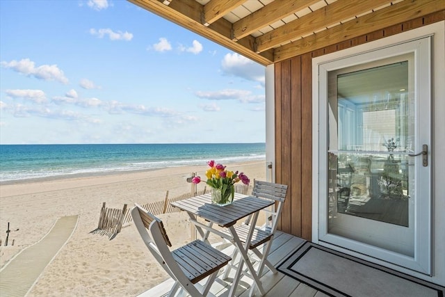 balcony with a beach view and a water view