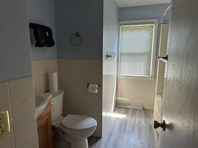 47 Mayfair St, East Longmeadow, MA 01028 - bathroom featuring tile walls, wood finished floors, vanity, and a wainscoted wall