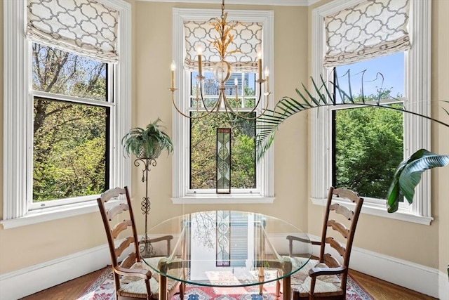 sunroom featuring a chandelier