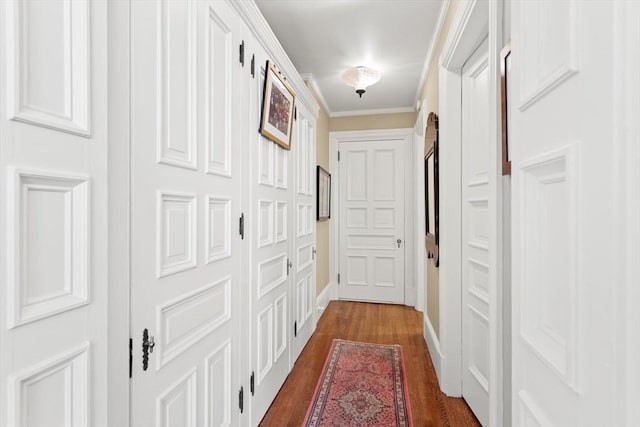 hallway with baseboards, dark wood-style floors, and crown molding