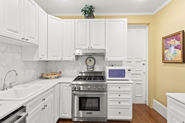 kitchen featuring stainless steel appliances, under cabinet range hood, a sink, light countertops, and white cabinets