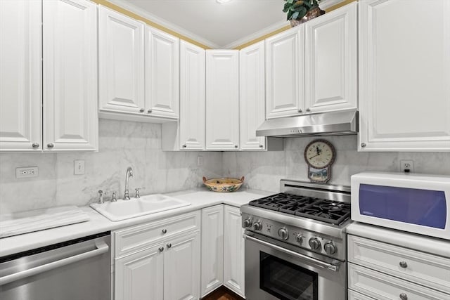 kitchen with appliances with stainless steel finishes, under cabinet range hood, a sink, white cabinets, and light countertops